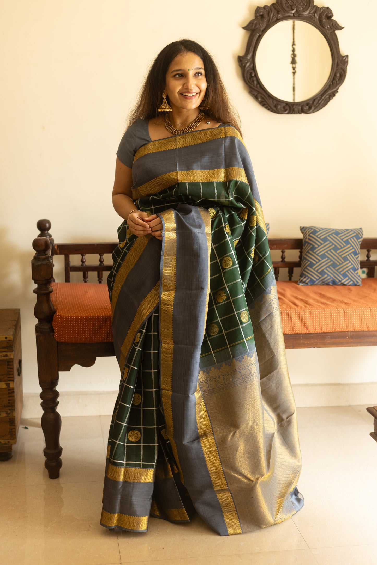 Woman wearing a traditional saree in a home setting